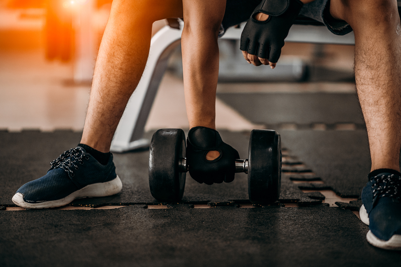 bodybuilder working out with dumbbell weights at the gymman
